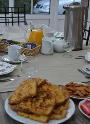 a table with a plate of toast and french fries at B&B Den Boomgaard Moorsel in Moorsel