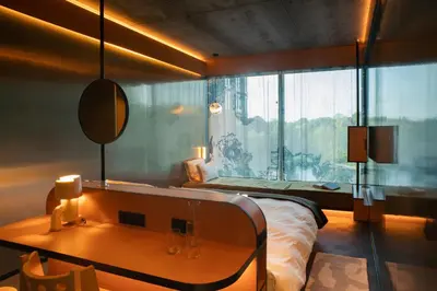 a bedroom with a bed and a table with a mirror at Mix Brussels --Gym & Wellness for adults only-- in Brussels