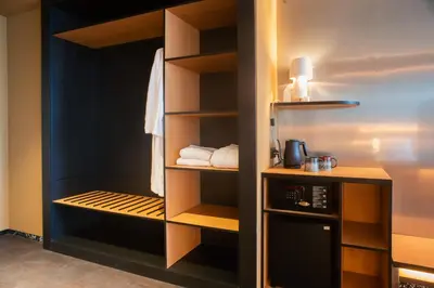 a walk in pantry with wooden shelves at Mix Brussels --Gym & Wellness for adults only-- in Brussels