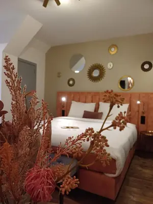 a bedroom with a large bed with white sheets at Manoir Hamme in Hamme