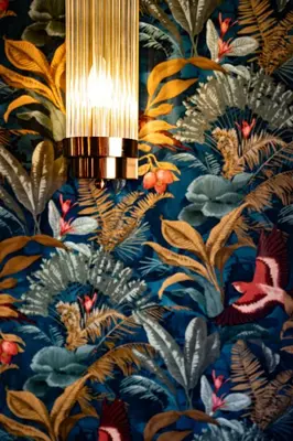 a light hanging from a wall with a floral wallpaper at Manoir Hamme in Hamme