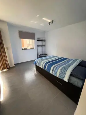 a bedroom with a bed with a blue and white blanket at brugsken, Sint-Niklaas in Sint-Niklaas