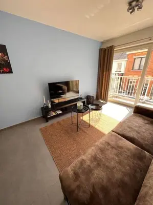 a living room with a couch and a table at brugsken, Sint-Niklaas in Sint-Niklaas