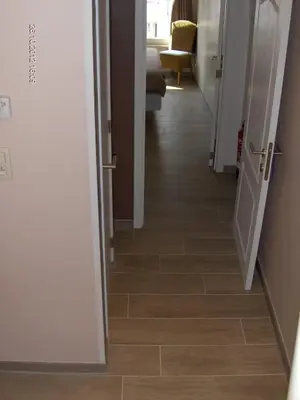 a hallway with a tile floor in a house at Wenceslas Cobergher in Scherpenheuvel-Zichem