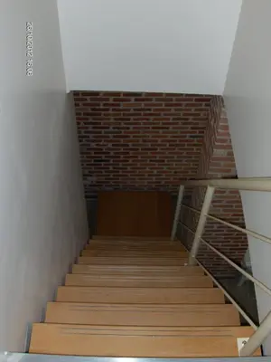 a staircase in a room with a brick wall at Wenceslas Cobergher in Scherpenheuvel-Zichem