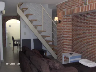 a living room with a staircase and a brick wall at Wenceslas Cobergher in Scherpenheuvel-Zichem