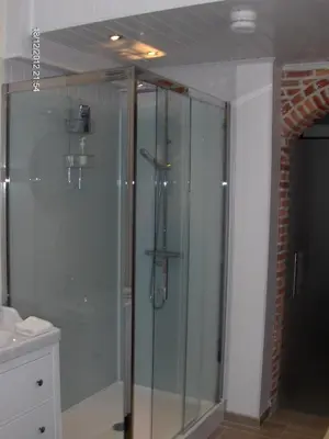 a glass shower in a bathroom with a sink at Wenceslas Cobergher in Scherpenheuvel-Zichem