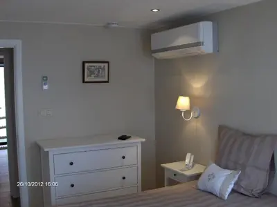 a bedroom with a bed with a dresser and a microwave at Wenceslas Cobergher in Scherpenheuvel-Zichem