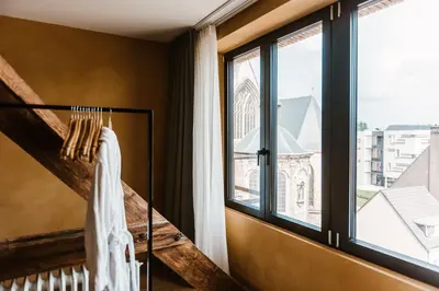 a room with a window and white towels hanging on a rack at Boutique Hotel Marie Marie in Dendermonde