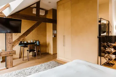 a bedroom with a loft bed and a wine cellar at Boutique Hotel Marie Marie in Dendermonde