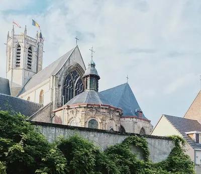 a large church with a clock tower and a cathedral at Boutique Hotel Marie Marie in Dendermonde