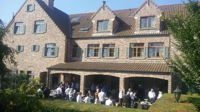 a group of people standing in front of a building at Hotel ABBEY in Grimbergen