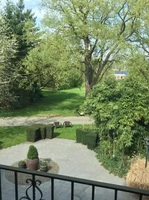 a view of a park with a fence and a patio at Hotel ABBEY in Grimbergen
