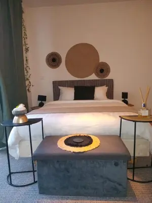 a bedroom with a bed with a table in front of it at Gallery Home in Brussels