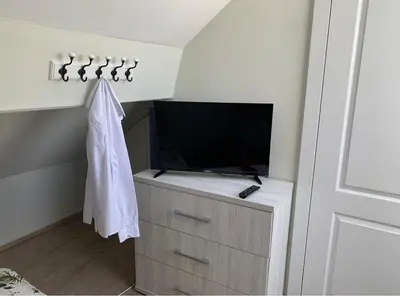 a living room with a tv and a dresser with a dresserngthngth at Un sommeil paisible in Brussels