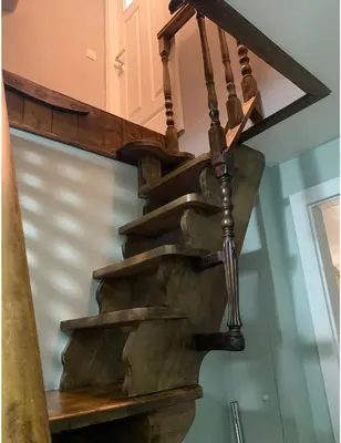 a spiral staircase with a stone tread stair case at Un sommeil paisible in Brussels