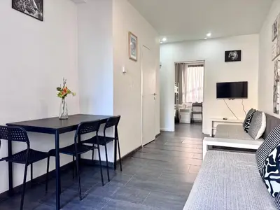 a living room with a table and chairs and a couch at Apartments Bex. in Antwerp