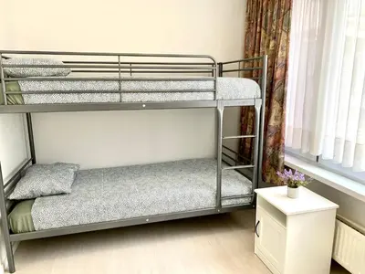 two bunk beds in a small room with a window at Apartments Bex. in Antwerp