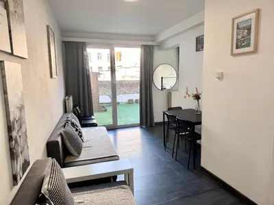 a living room with a couch and a table at Apartments Bex. in Antwerp