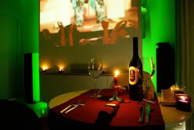 a table with a bottle of wine and two glasses at Nooz - Something Different? in Grobbendonk