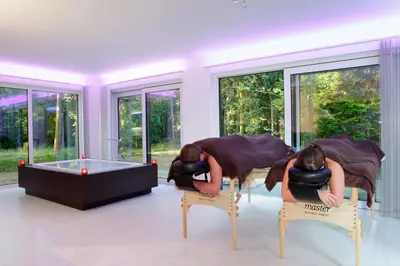 two women sitting on chairs in a room with a tub at Nooz - Something Different? in Grobbendonk