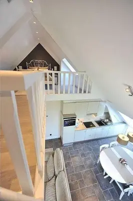 a living room with a staircase and a kitchen at Villa71 in Rijkevorsel