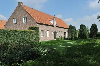 a large brick house with a green yard at Villa71 in Rijkevorsel