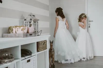 two girls in white dresses standing in a room at Villa71 in Rijkevorsel