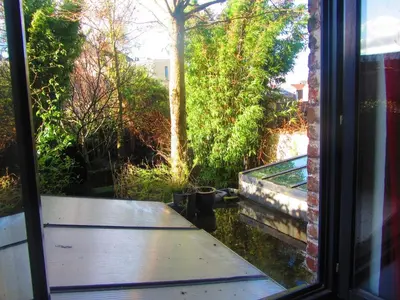 a window view of a porch with a table outside at B&B Faja lobi in Ghent