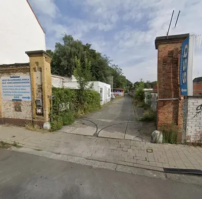 an empty street next to a brick building at B&B Faja lobi in Ghent