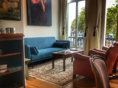 a living room with a blue couch and a table at Perfect location & Parking in Antwerp