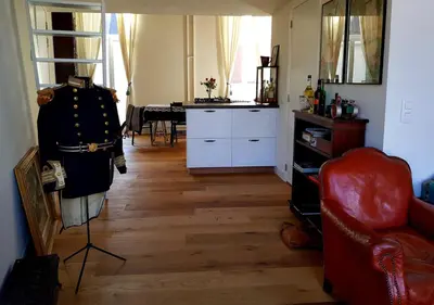 a living room with a red chair and a table at Perfect location & Parking in Antwerp