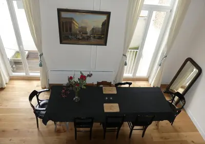 a black table and chairs in a room with windows at Perfect location & Parking in Antwerp