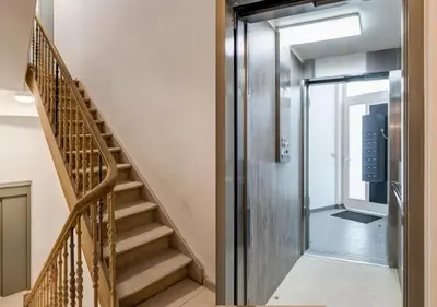 a hallway with a staircase and a glass door at Perfect location & Parking in Antwerp