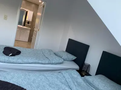 two beds sitting next to each other in a room at Apartment Brussels Airport and NATO OTAN in Machelen
