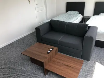 a living room with a couch and a coffee table at Apartment Brussels Airport and NATO OTAN in Machelen