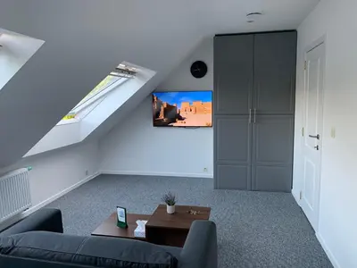 a living room with a couch and a window at Apartment Brussels Airport and NATO OTAN in Machelen