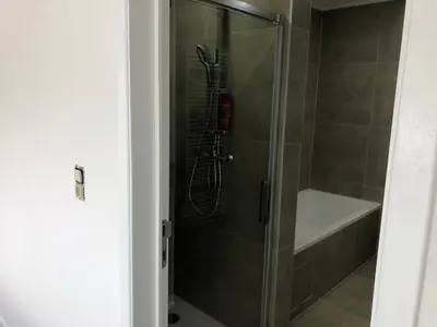 a shower with a glass door in a bathroom at Apartment Brussels Airport and NATO OTAN in Machelen