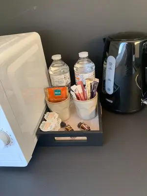 a coffeemaker with a coffee pot and a tray with pens at Apartment Brussels Airport and NATO OTAN in Machelen