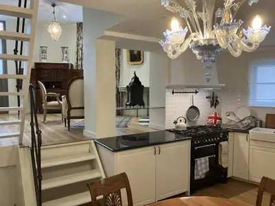a kitchen with a stove and a dining room at La Maison des Sources in Brussels