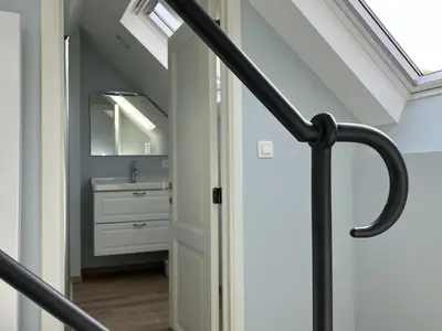 a bathroom with a sink and a skylight at La Maison des Sources in Brussels