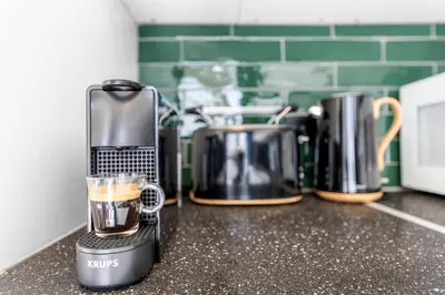 a cup of coffee sitting on top of a counter at Central & luminous apartment in Antwerp