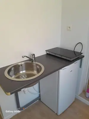 a bathroom counter with a sink and a laptop on it at 1 bedroom studio sleeps 4 in Brussels
