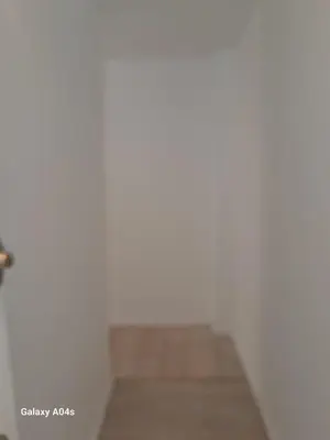 a room with white walls and a wooden floor at 1 bedroom studio sleeps 4 in Brussels