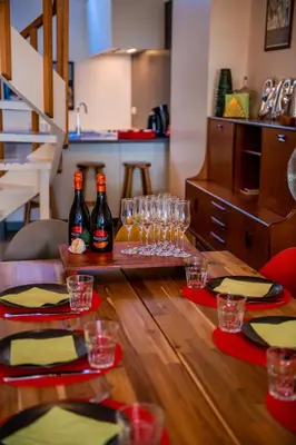 a table with wine bottles and glasses on top of it at Unieke woning in het historisch stadscentrum in Antwerp