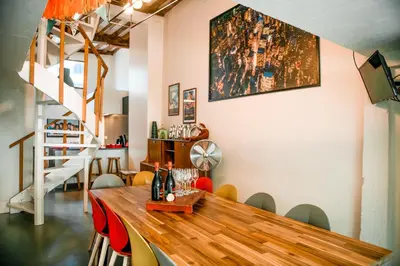 a dining room with a wooden table and chairs at Unieke woning in het historisch stadscentrum in Antwerp