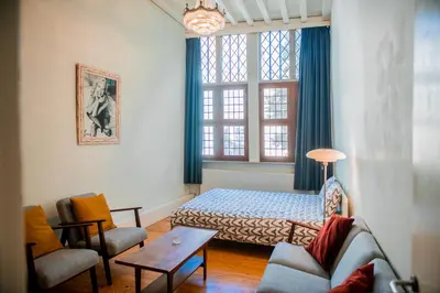 a room with a bed and a couch and a table at Unieke woning in het historisch stadscentrum in Antwerp