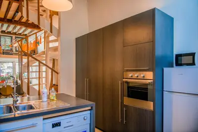 a kitchen with a sink and a refrigerator at Unieke woning in het historisch stadscentrum in Antwerp