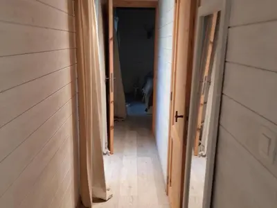 a hallway leading to a room with wooden floors at Oud-Turnhout Nature Chalet in Oud-Turnhout