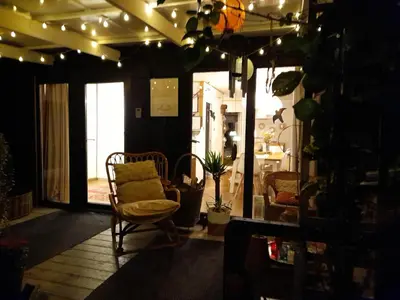 a living room with a chair and a window at Oud-Turnhout Nature Chalet in Oud-Turnhout